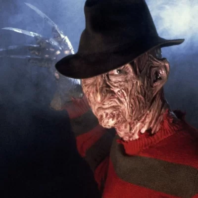 Close-up of Freddy Krueger in his signature hat and clawed glove.